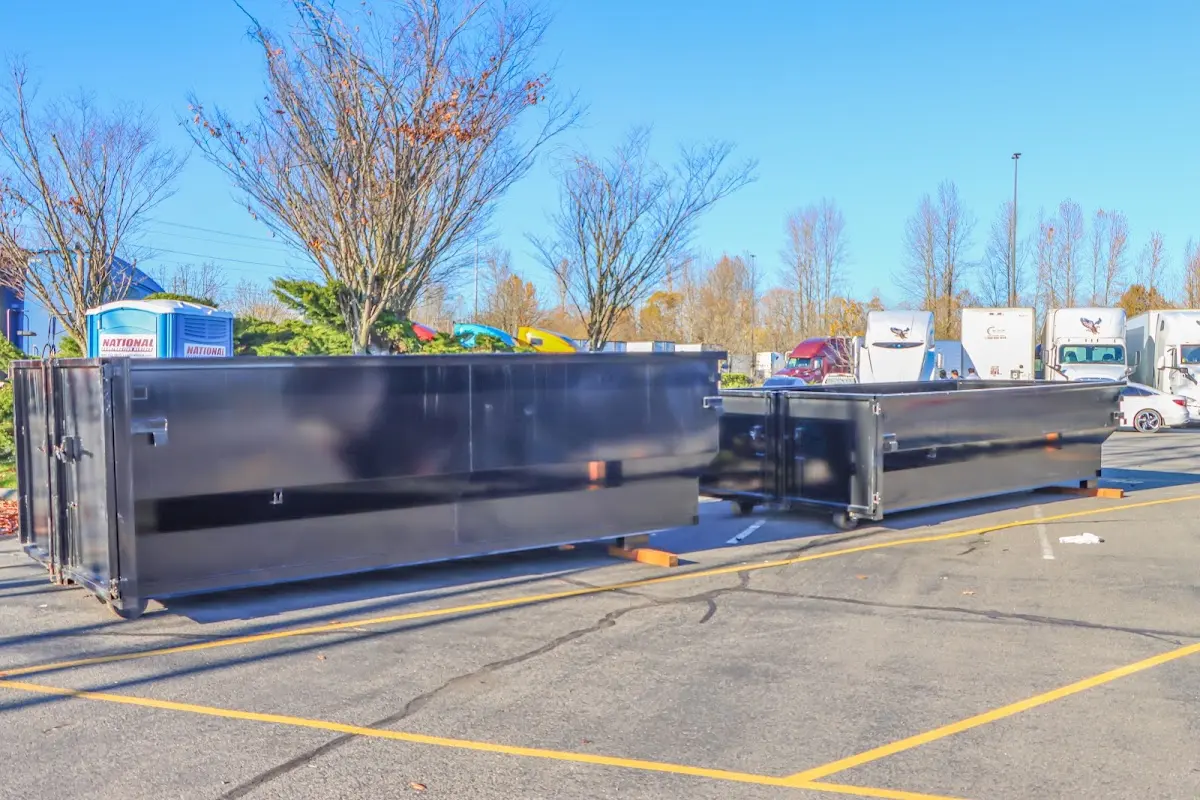 Professional dumpster rental service with roll-off container on residential driveway in Countryside